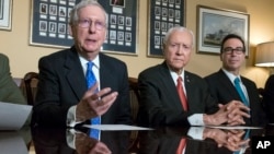 From left, Senate Majority Leader Mitch McConnell, R-Ky., Senate Finance Committee Chairman Orrin Hatch, R-Utah, and Treasury Secretary Steven Mnuchin speak to reporters in Washington, Nov. 9, 2017. 