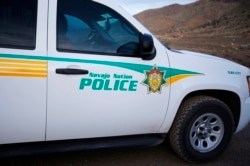A Navajo police officer patrols in his vehicle on the Navajo Reservation, by a remote section of the Grand Canyon near Little Colorado River, Arizona June 23, 2013.