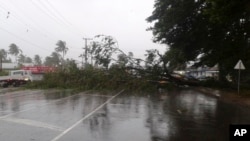 FILE - A tree blocks a road after it was blown down by the encroaching cyclone Winston in Nakasi, Fiji, Feb. 20, 2016. 
