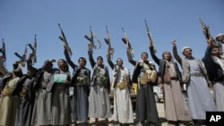 FILE - Shiite Houthi tribesmen hold their weapons as they chant slogans during a tribal gathering showing support for the Houthi movement, in Sanaa, Yemen, Sept. 21, 2019.