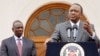 Kenya's President Uhuru Kenyatta, right, accompanied by Deputy President William Ruto, left, speaks to the media about the upcoming visit of U.S. President Barack Obama, among other issues, at State House in Nairobi, Kenya, July 21, 2015.