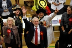 FILE - Britain's Labor Party leader Jeremy Corbyn waves after arriving for the declaration at his constituency in London, June 9, 2017.