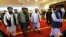 FILE - Taliban co-founder Mullah Abdul Ghani Baradar, center, arrives with other members of the Taliban delegation for attending an international peace conference in Moscow, Russia, Apr. 21, 2021.