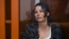 FILE - U.S.-Russian national Ksenia Karelina, also known as Ksenia Khavana, sits in a glass cage in a court room in Yekaterinburg, Russia, June 20, 2024. 