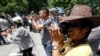 FILE - Blogger Nguyen Huu Vinh, front, takes photos while attending an anti-China protest in Hanoi.