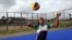 Florence Amara in action on the volleyball court, Freetown, Sierra Leone, July 22, 2015. (N. deVries/VOA News)