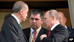 Turkish President Recep Tayyip Erdogan, left, speaks to Russian President Vladimir Putin, right, as he leaves after their meeting in Putin's residence in the Russian Black Sea resort of Sochi, Russia, Wednesday, May 3, 2017.