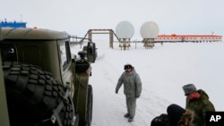 Russian soldiers stand at a radar facility on the Alexandra Land island near Nagurskoye, Russia, May 17, 2021. The facility is Russia's northernmost military outpost. 