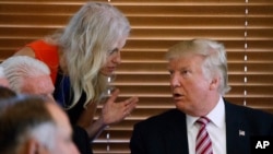 FILE - Then Republican presidential candidate Donald Trump, right, talks with his his then campaign manager, now senior adviser, Kellyanne Conway during a visit to Brook Park, Ohio, Sept. 5, 2016. Trump has pledged that his incoming administration will “do all it can to ensure the Cuban people can finally begin their journey toward prosperity and liberty."