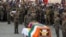 FILE - Indian soldiers pay their respects during the funeral of their comrade, Tibetan-origin India's special forces soldier Nyima Tenzin, in Leh on Sept. 7, 2020. 