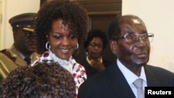 FILE - President Robert Mugabe and his wife Grace arrive to chair ZANU PF's Politburo meeting at the party headquarters in Harare, Feb. 15, 2017. 