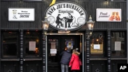 A restaurant demands the 2G rule, that means only vaccinated or recovered customers are allowed to enter in Cologne, Germany, Jan. 7, 2022. New