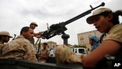 Shi'ite fighters known as Houthis wearing army uniforms ride in a pickup while patrolling in a street in Sana'a, Yemen, July 24, 2015.