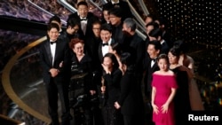 Kwak Sin Ae and Bong Joon-ho win the Oscar for Best Picture for "Parasite" at the 92nd Academy Awards in Los Angeles, Calif., Feb. 9, 2020. 