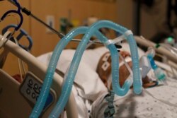 FILE - Ventilator tubes are attached to a COVID-19 patient at Providence Holy Cross Medical Center in the Mission Hills section of Los Angeles, Nov. 19, 2020.
