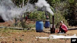 FILE - A displaced Syrian woman prepares food for her family outside their tent, at a refugee camp, near the eastern town of Kab Elias, Lebanon, April 29, 2014. A multi-billion dollar aid appeal for Syria is currently only 9 percent funded, the U.N. warns.