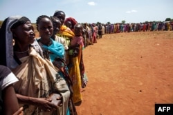 FILE - Internally displaced people, who recently arrived in Wau, South Sudan due to armed clashes in surrounding villages, wait to be registered by the International Organization for Migration and the World Food Program, May 11, 2016.