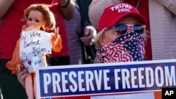 FILE - A supporter of President Donald Trump is seen during a rally in Milwaukee after it was announced that the president had been defeated by Democrat Joe Biden, Nov. 7, 2020.