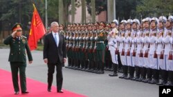 FILE - U.S. Defense Secretary Jim Mattis, right, and his Vietnamese counterpart, Ngo Xuan Lich, review an honor guard before heading for talks in Hanoi, Vietnam, Jan. 25, 2018.