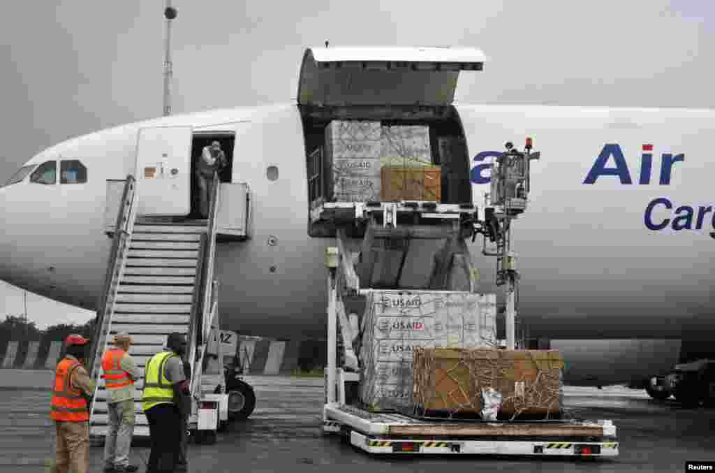 Workers unload the first consignment of U.S. Agency for International Development (USAID) medical equipment towards the fight against Ebola at the Roberts International Airport in Monrovia, Aug. 24, 2014.