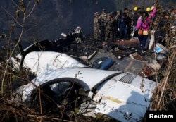 Rescue teams work to retrieve bodies from the wreckage at the crash site of an aircraft carrying 72 people in Pokhara in western Nepal Jan. 15, 2023.