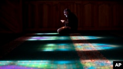 A Crimean Tatar man prays at a mosque in Bakhchysarai, Ukraine, March 10, 2014. 