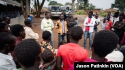 FILE - A Ugandan government official briefs newly arrived refugees on the laws of Uganda.