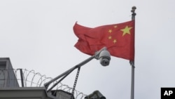 The flag of China flies behind a security camera over the Chinese Consulate in San Francisco, July 23, 2020.