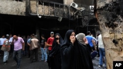Iraqi women wait to hear about family members who went missing after a truck bomb hit Karrada, a busy shopping district in the center of Baghdad, Iraq, July 3, 2016. 