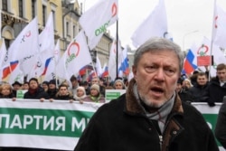 FILE - Liberal politician Grigory Yavlinsky participates in a march in memory of murdered Kremlin critic Boris Nemtsov, in central Moscow, Russia, Feb. 24, 2019.
