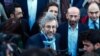 Can Dundar, the editor-in-chief of opposition newspaper Cumhuriyet, center-left, and Erdem Gul, the paper's Ankara representative, center-right, speak to the media before the start of their trial in Istanbul, April 1, 2016.