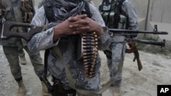 FILE - Afghan security forces guard a checkpoint in Spein Boldak at the border with Pakistan, Kandahar province, Afghanistan, Jan. 25, 2016.