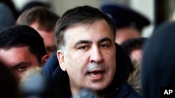 Former Georgian president Mikheil Saakashvili speaks with journalists near the Fairmont Grand Hotel in Kiev, Ukraine, Friday, Feb. 9, 2018. Saakashvili claimed that unidentified armed people wearing military uniform tried to arrest him inside the hotel on Friday. 