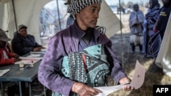 A Basotho woman prepares to cast her ballot, at a polling station on June 3, 2017 in Maseru, during Lesotho's general election.