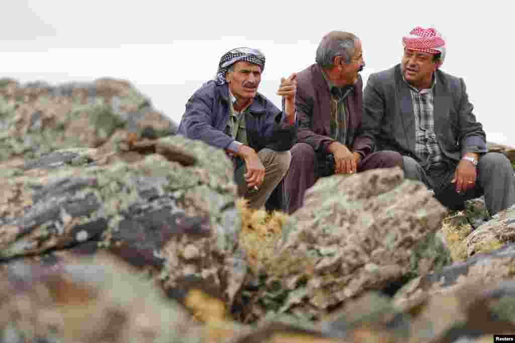 Turkish Kurds watch the Syrian town of Kobani, near the Turkey-Syria border, Oct. 16, 2014. 