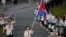 FILE - Cambodian flag-bearer Davin Sorn leads her nation's contingent in the athletes parade during the opening ceremonies of the London 2012 Olympic Games at Olympic Stadium, July 27, 2012. 