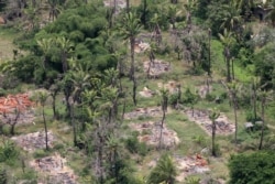 FILE - An aerial view shows burned-down villages once inhabited by the Rohingya seen from Myanmar military helicopters headed to northern Rakhine state, Myanmar, May 1, 2018.