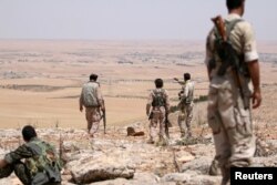 FILE - Fighters allied with Syrian Democratic Forces (SDF) are seen near Manbij, northern Syria, June 1, 2016.