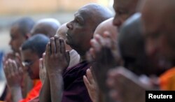 Buddhist monks take part in a prayer ceremony at a buddhist temple for the victims, three days after a string of suicide bomb attacks on churches and luxury hotels across the island on Easter, in Colombo, Sri Lanka, April 24, 2019.