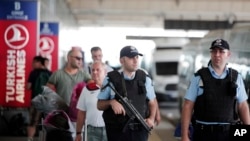 Turkish police officers patrol outside Istanbul's Ataturk airport, June 29, 2016. 