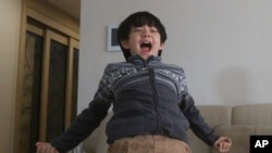 Parasite actor Jeong Hyeonjun celebrates as he watches a live broadcast of South Korean director Bong Joon Ho receiving the award for best original screenplay for "Parasite" at the Oscars, in Seoul, Feb. 10, 2020. 