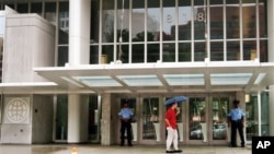 FILE - Security guards stand at the entrance of the headquarters of the World Bank, in Washington, Aug. 1, 2004.