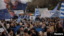 People gather during a protest against a bill allowing same-sex marriage ahead of the vote in parliament in Athens, Greece, Feb. 11, 2024.