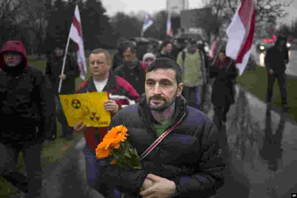 Demonstrators march marking the 31st anniversary of the Chernobyl nuclear power plant disaster in Minsk, Belarus, April 26, 2017.&nbsp;About 400 people have marched in the capital of Belarus to mark the anniversary of the Chernobyl nuclear power plant disaster and protest the construction of a nuclear plant in Belarus.