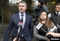 Michael Arnold, left, and Lissa Casey, attorneys representing Ammon Bundy, address the media covering the hearing of militia members outside United States District Court in Portland, Oregon, Jan. 27, 2016.