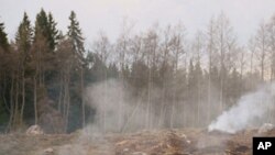 Early farmers' use of controlled forest burns, like this one in current-day Uganda, could have begun releasing climate changing gases into the atmosphere 8,000 years ago.