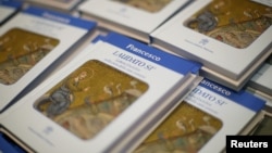 Pope Francis' new encyclical titled "Laudato Si (Be Praised), On the Care of Our Common Home", is displayed during the presentation news conference at the Vatican, June 18, 2015.