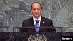 Egyptian women show their inked fingers after casting their votes at a polling station in Cairo. Egyptians are voting on a draft for their country's new constitution.
