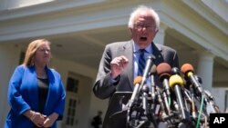 Democratic presidential candidate Sen. Bernie Sanders, I-Vt., accompanied by his wife Jane Sanders, speaks to reporters outside the White House in Washington, June 9, 2016, following a meeting with President Barack Obama.