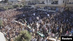 A man, holding a national flag with a poster of Turkey&#39;s founder Kemal Ataturk, watches as thousands of Turks clash with security as they try to break through barricades mounted around the prison and courthouse complex in Silivri, in the outskirts of Istanbul.